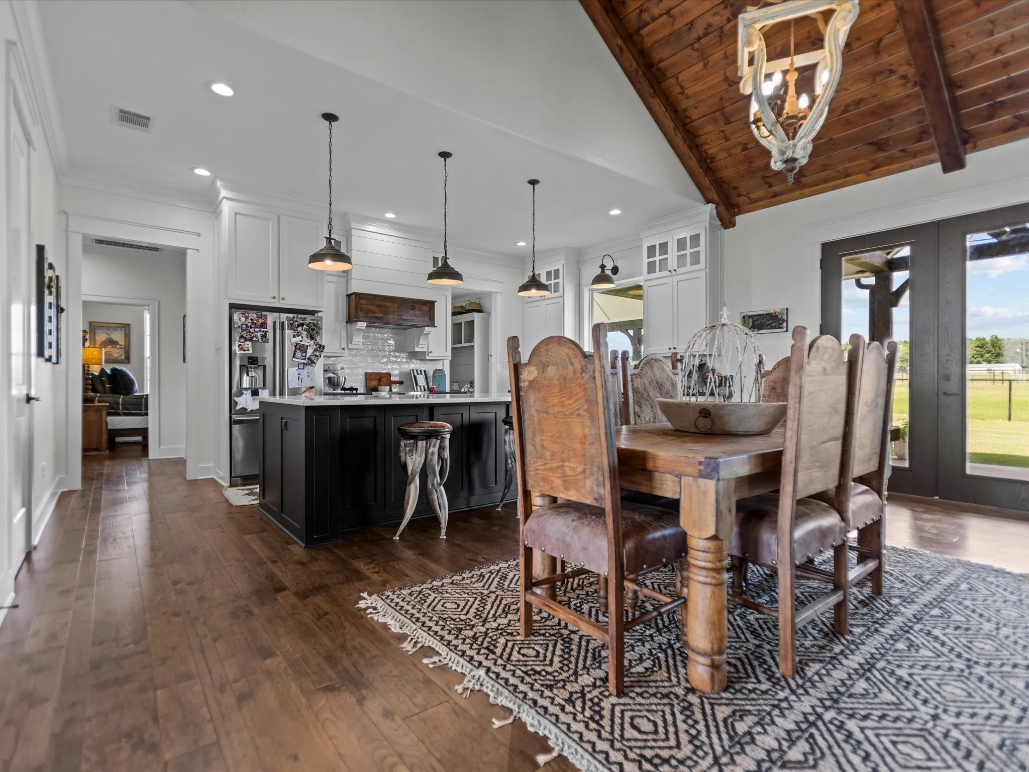 Dining room with dark wood finished floors, recessed lighting, french doors, and crown molding