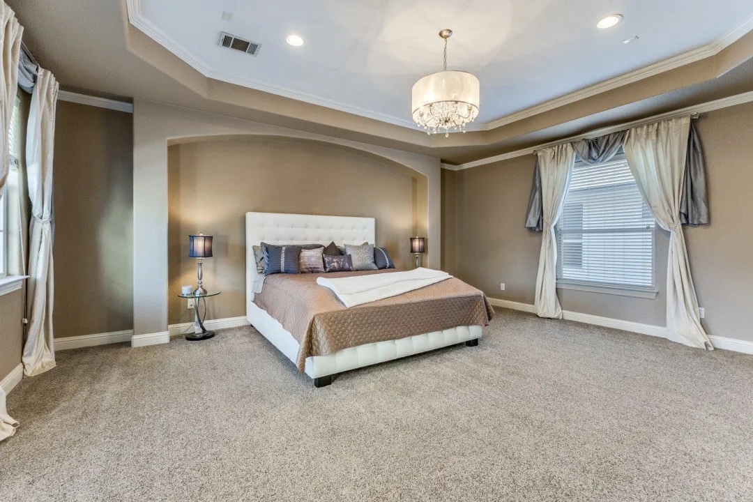 2nd floor primary bedroom featuring ornamental molding and a chandelier