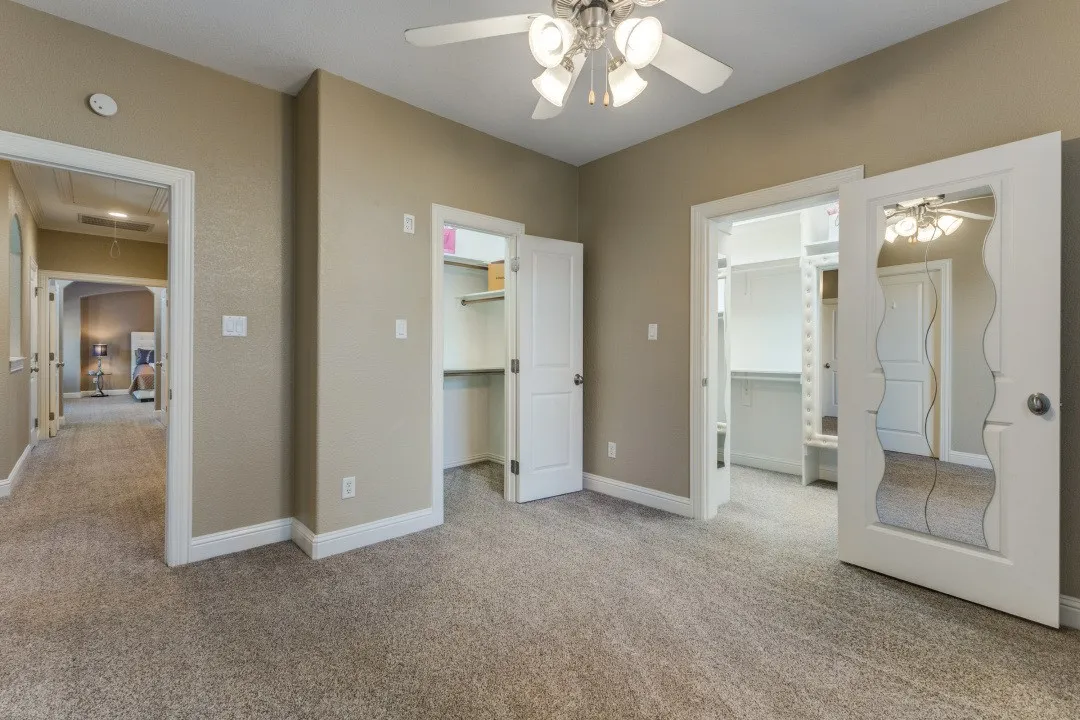 Spare room with light carpet and a ceiling fan