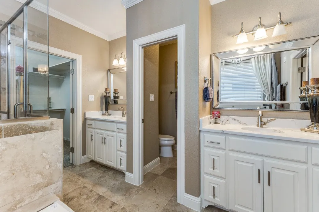 2nd floor primary
bathroom with a shower stall, a jetted tub, ornamental molding, and stone finish floors