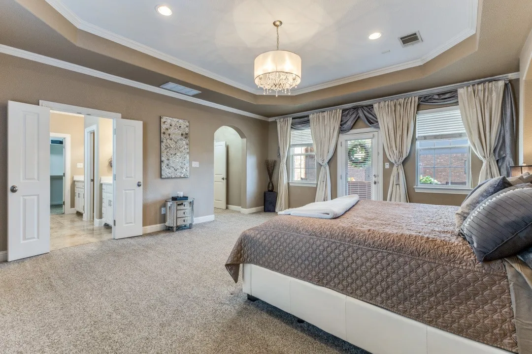 2nd floor primary bedroom featuring ornamental molding and a chandelier