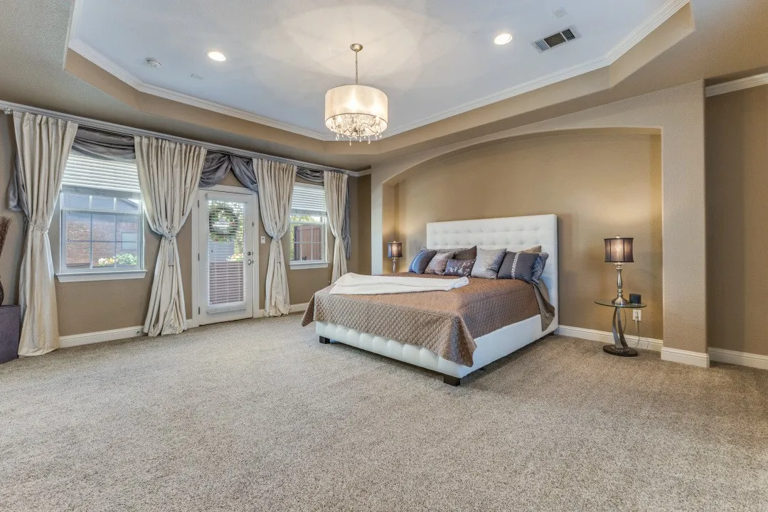 2nd floor primary bedroom featuring ornamental molding and a chandelier