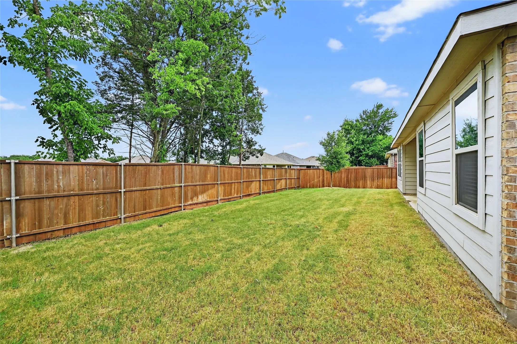 View of fenced backyard