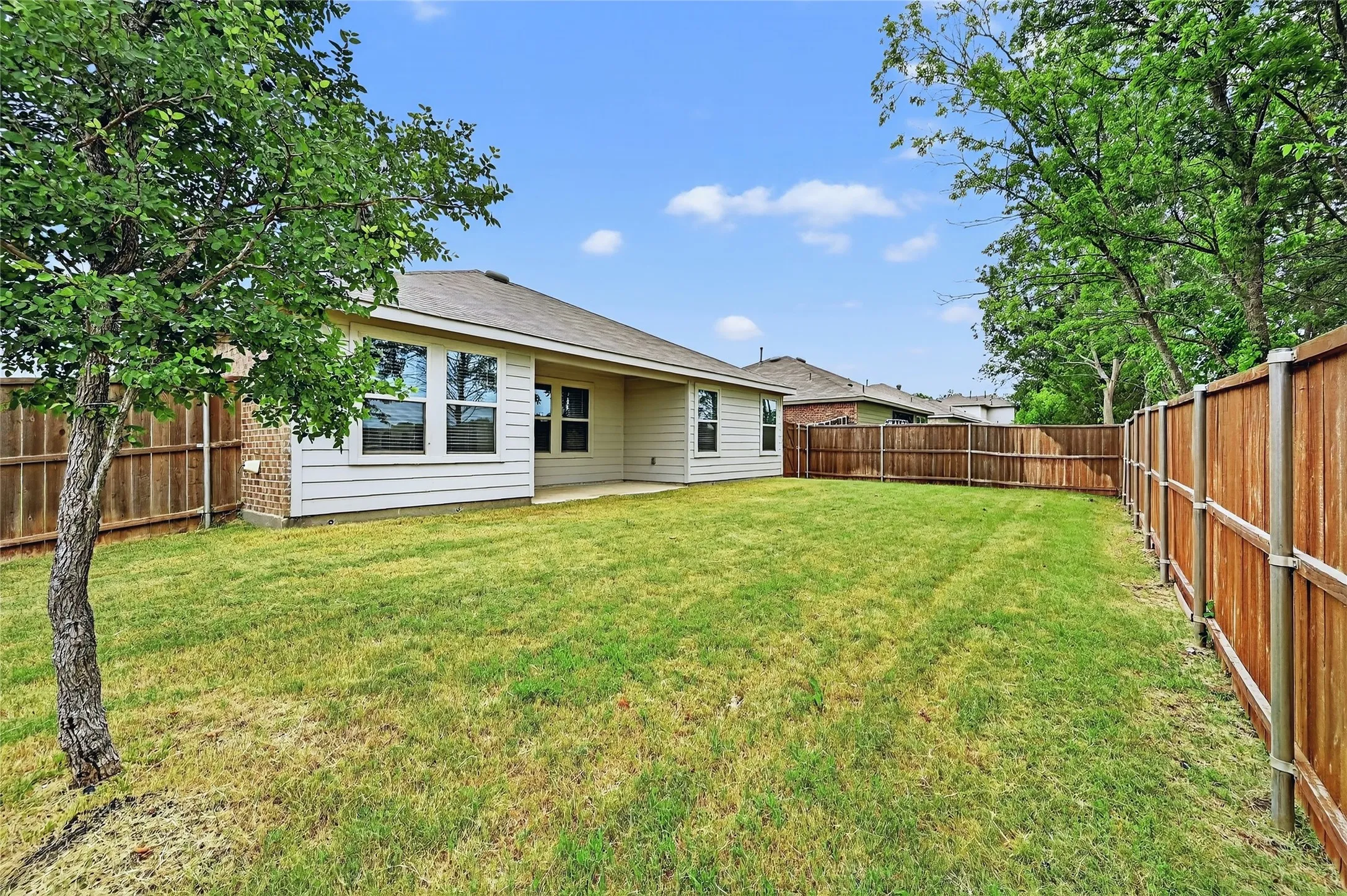 Back of house featuring a fenced backyard
