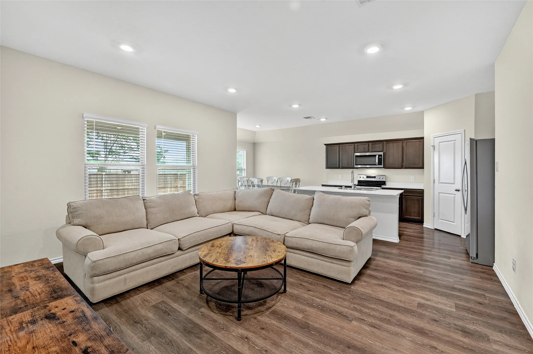 Living area with dark wood-style floors and recessed lighting