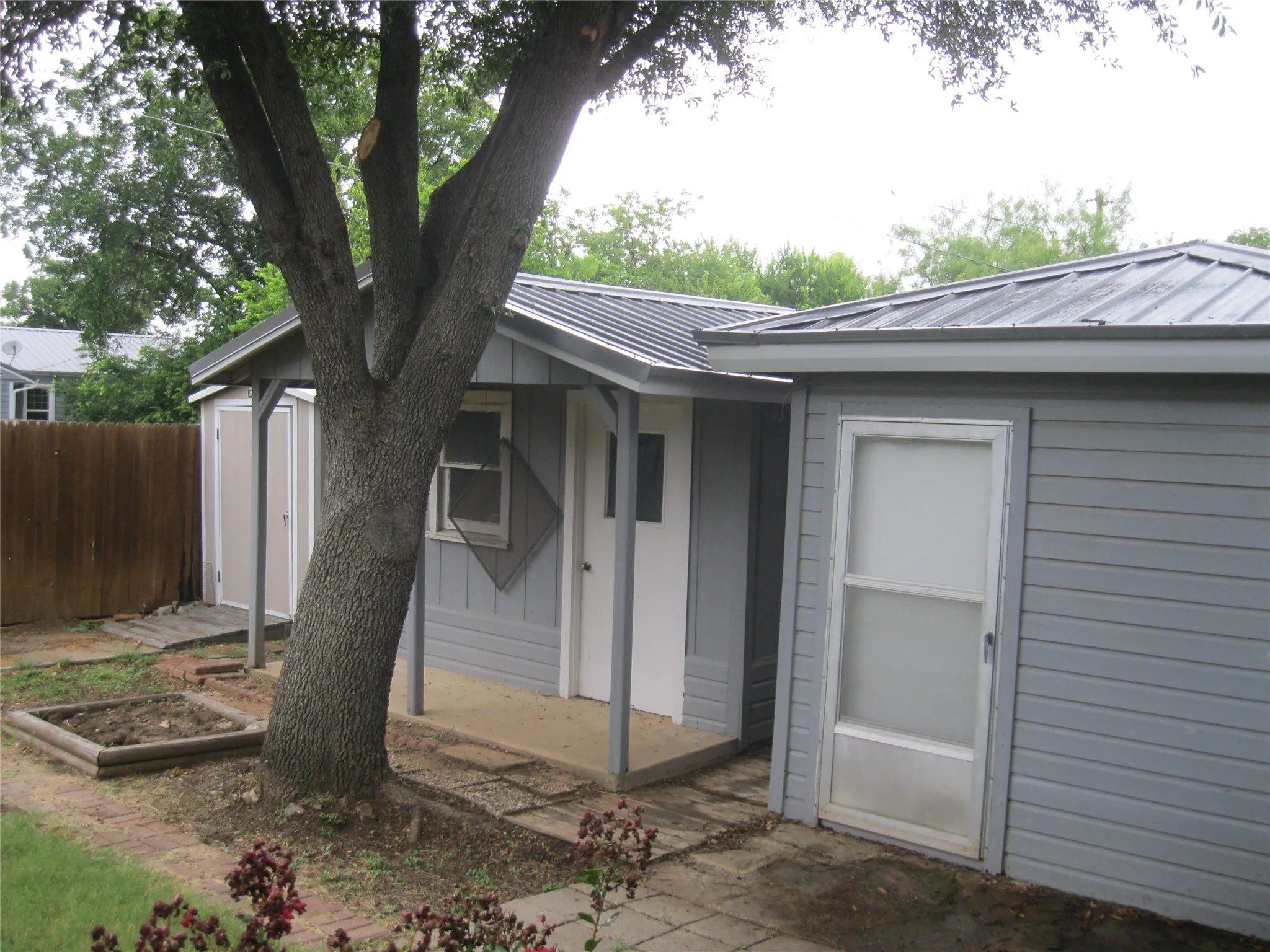 View of exterior entry with a metal roof