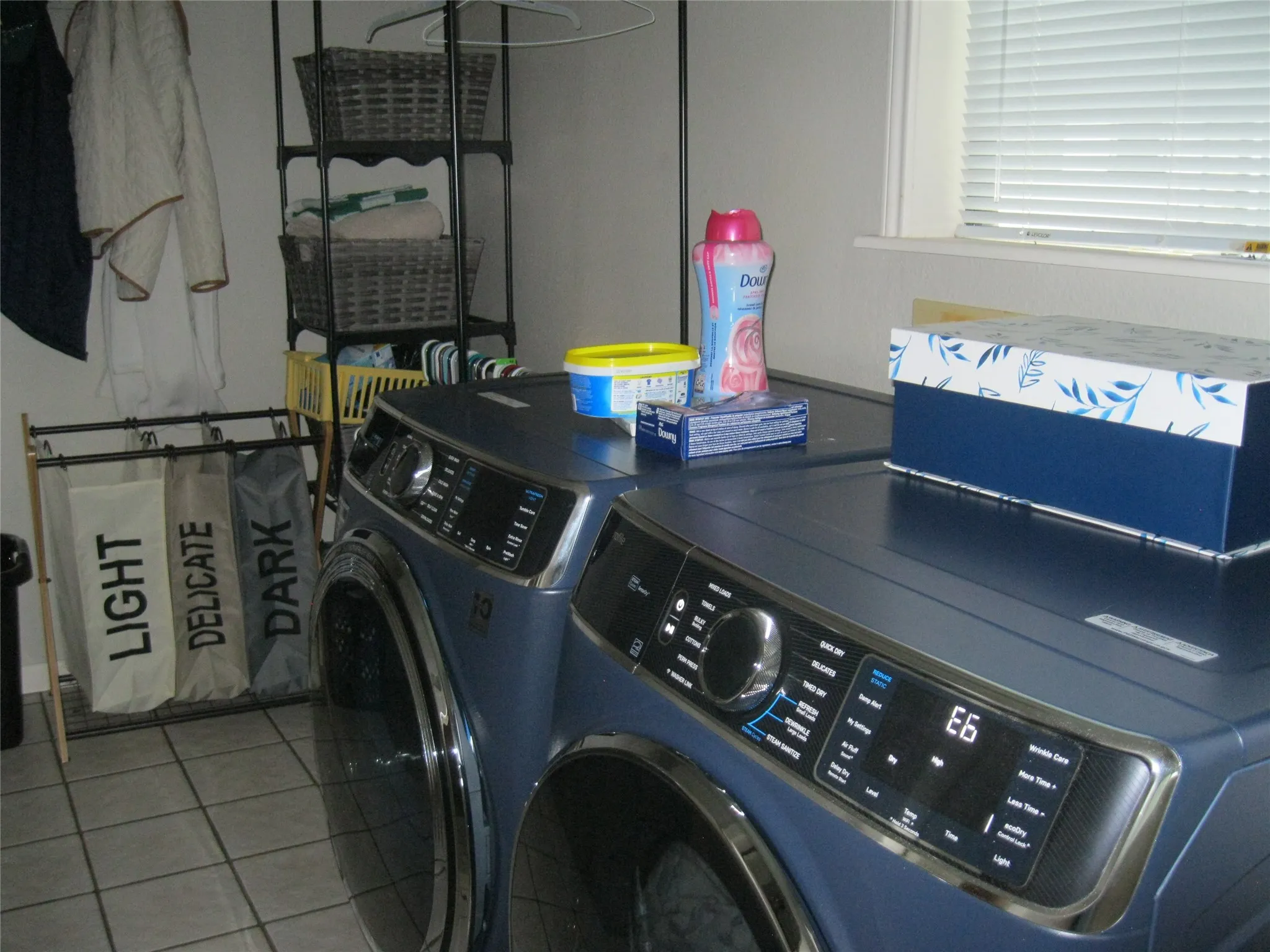 Laundry area featuring washing machine and dryer and tile patterned flooring