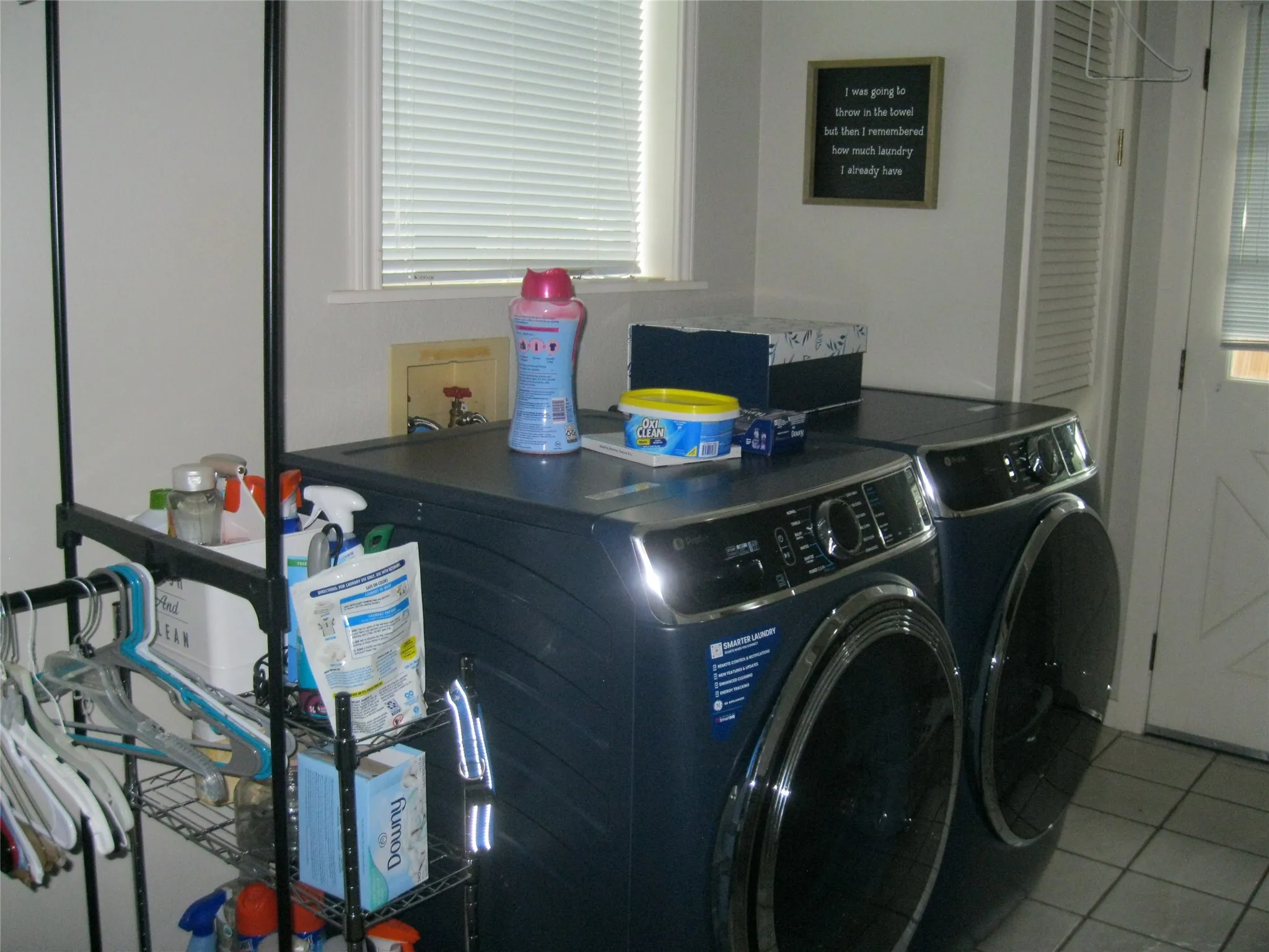 Laundry room featuring washer and dryer and tile patterned floors