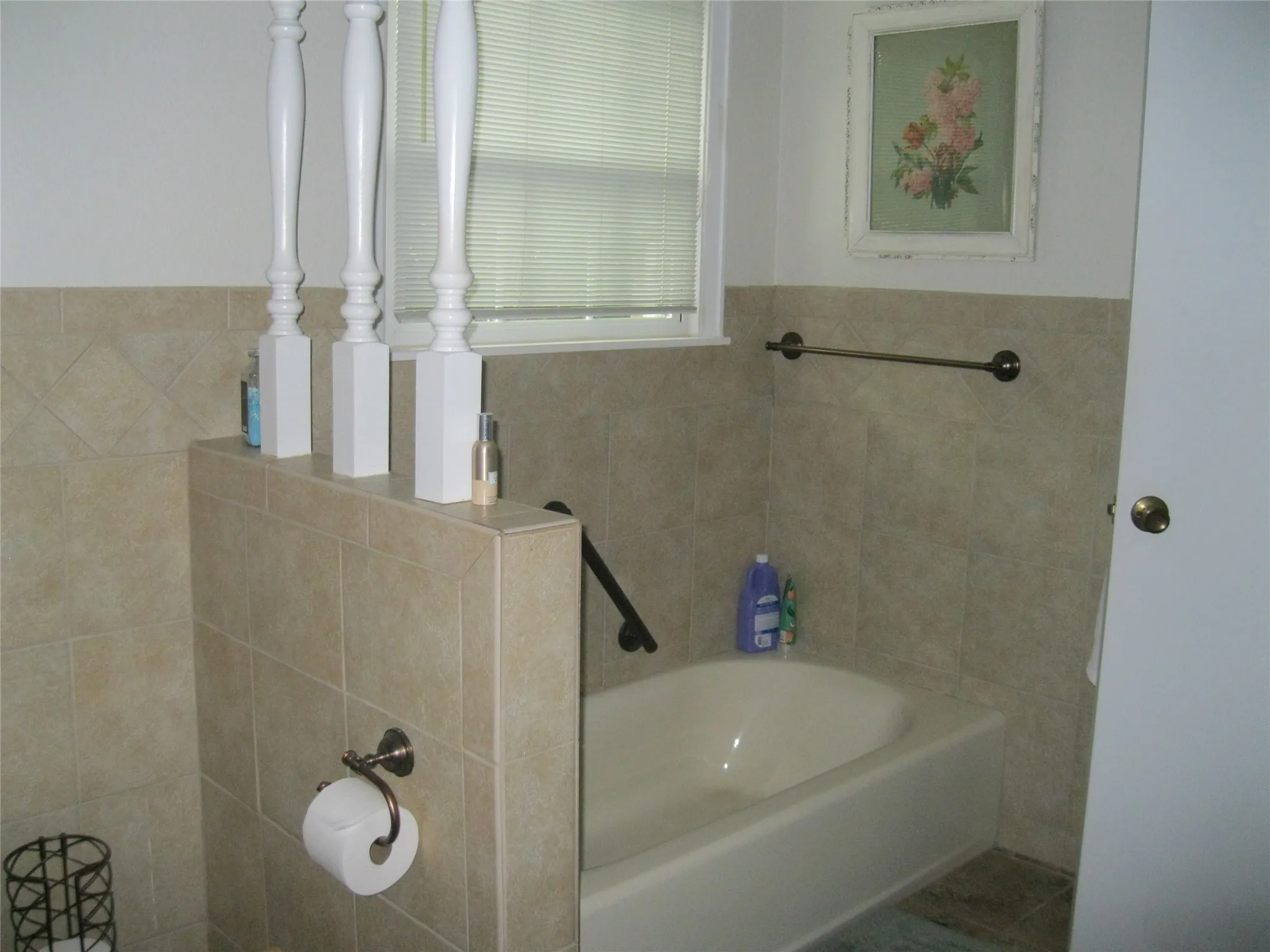 Bathroom with a bath and tile walls