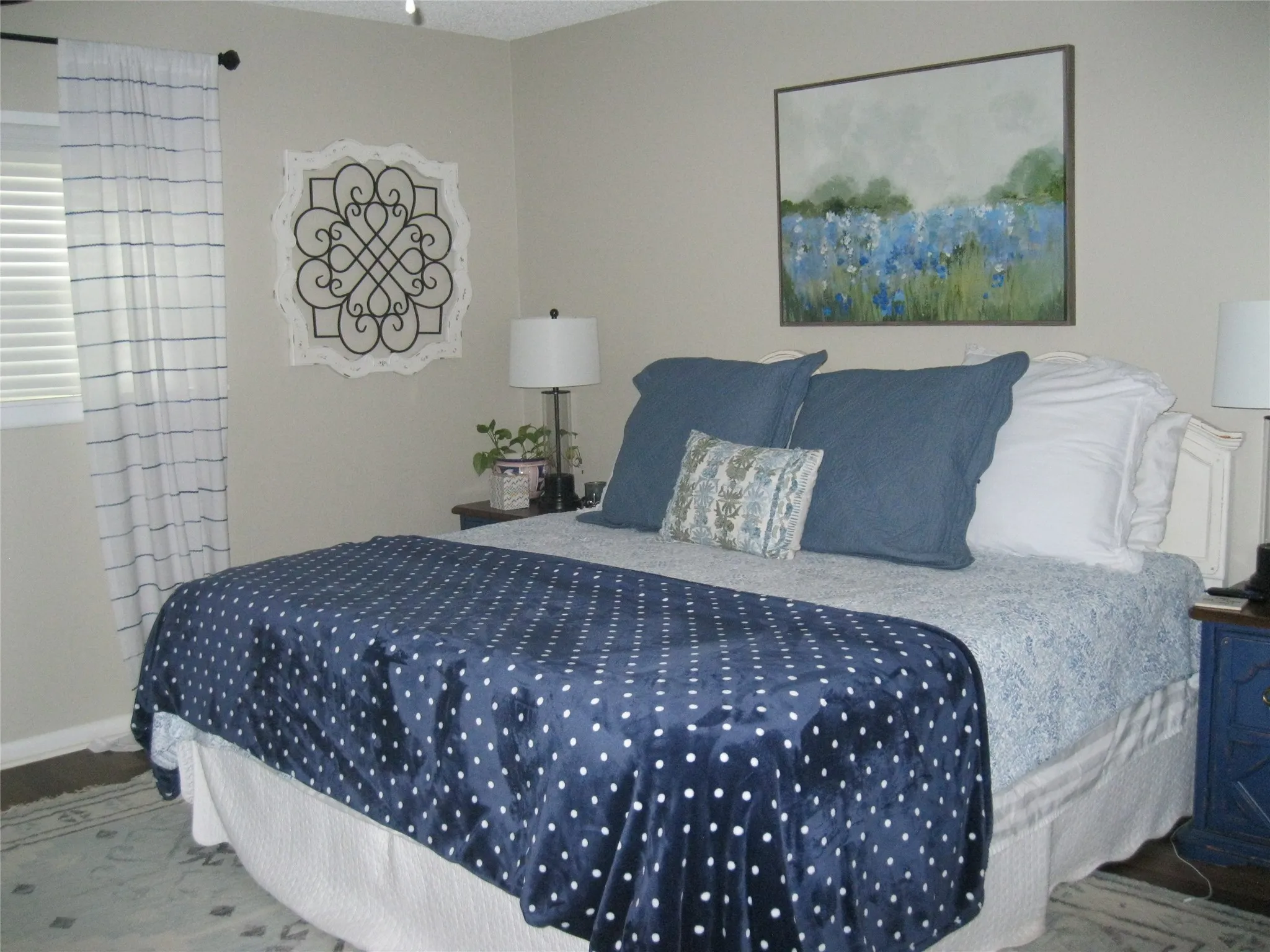 Bedroom with wood finished floors and baseboards