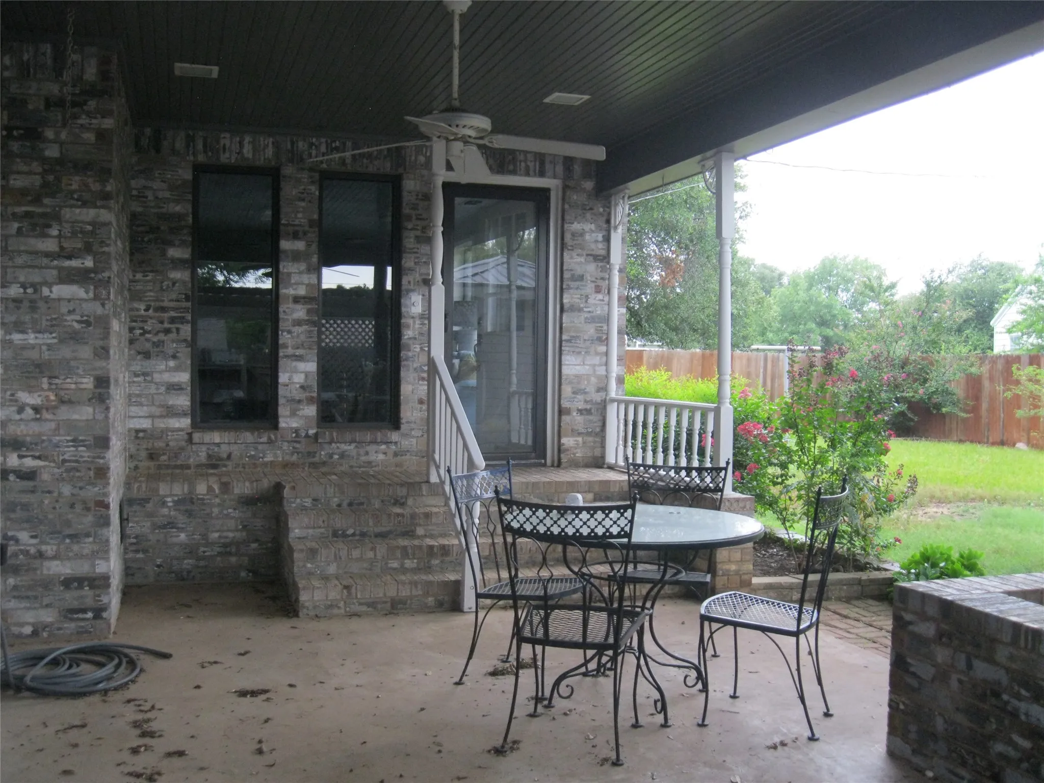 Fenced backyard featuring a ceiling fan, a patio area, and outdoor dining space