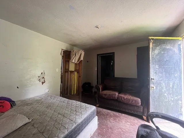Carpeted bedroom featuring a textured ceiling