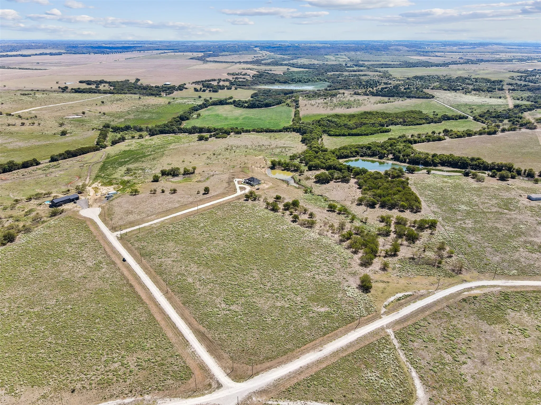 Aerial view with a water view and a rural view