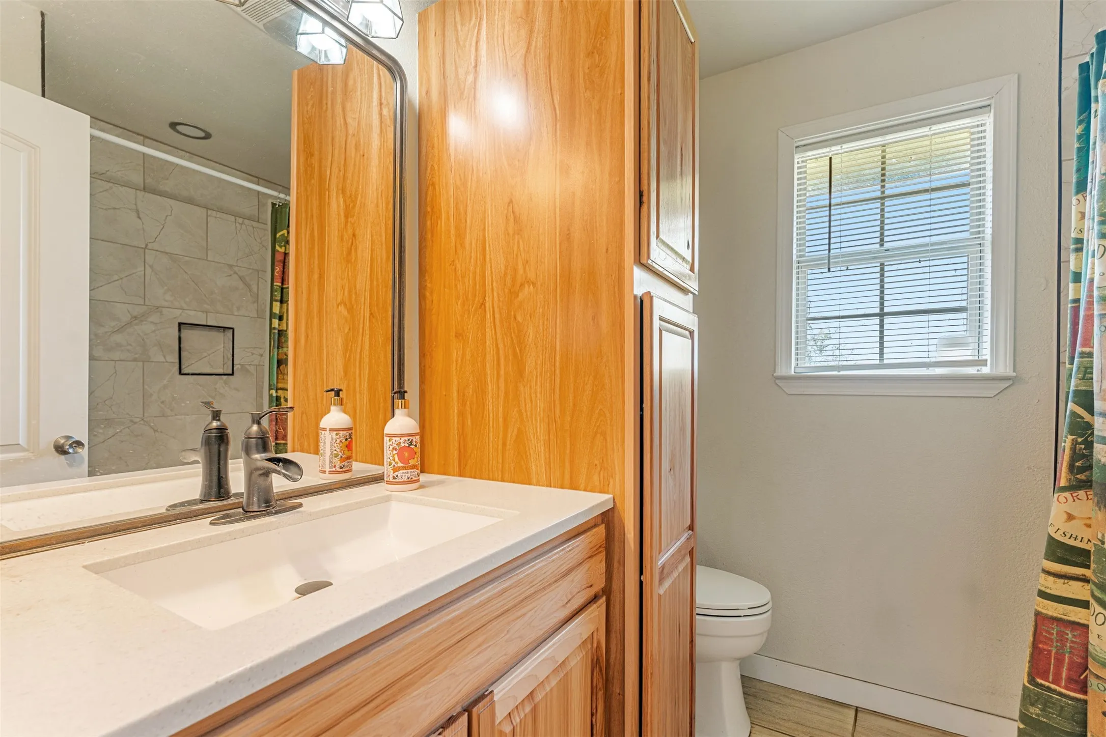 Full bathroom featuring vanity and a shower with shower curtain