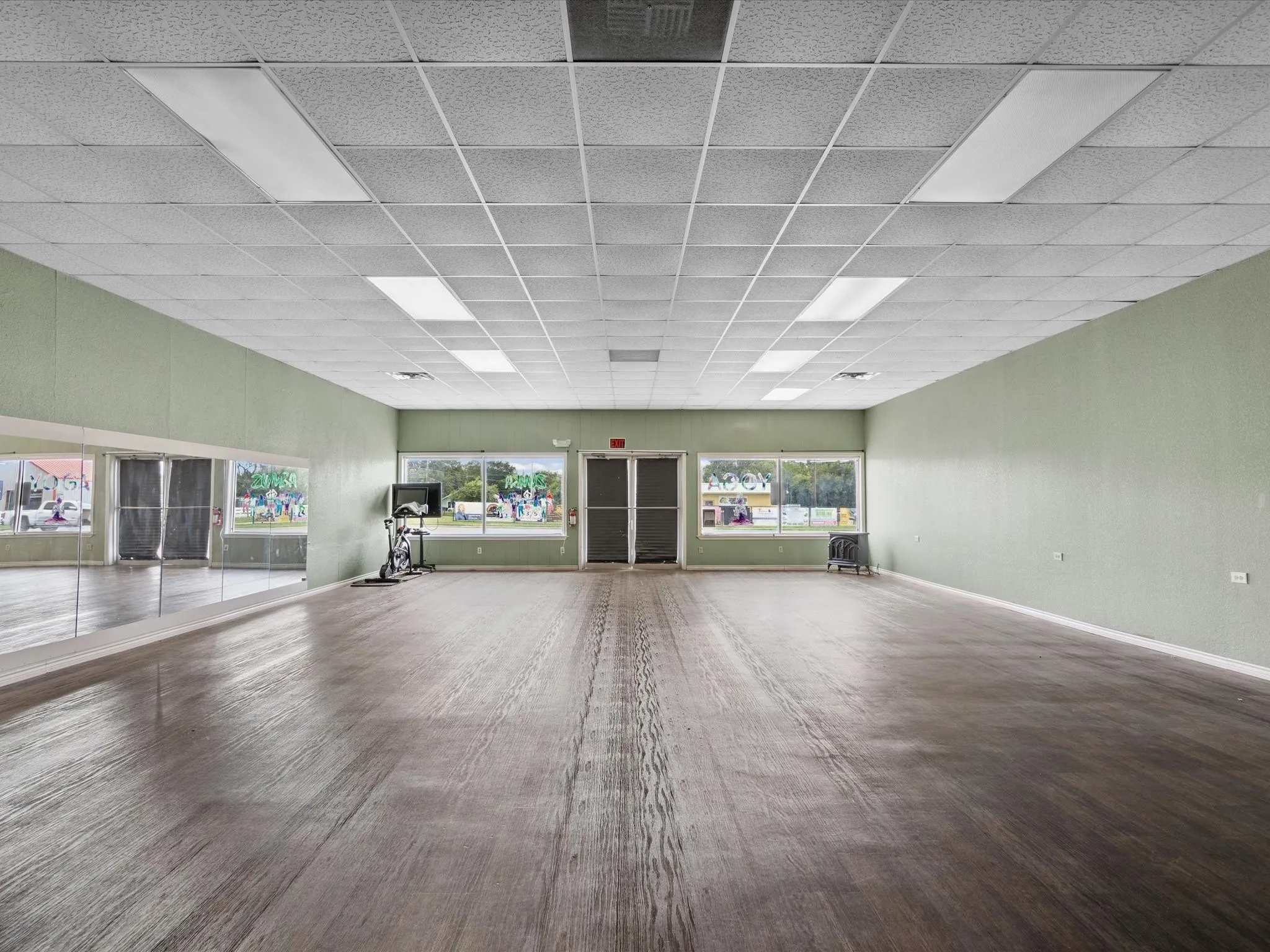 Unfurnished living room with a drop ceiling and wood finished floors