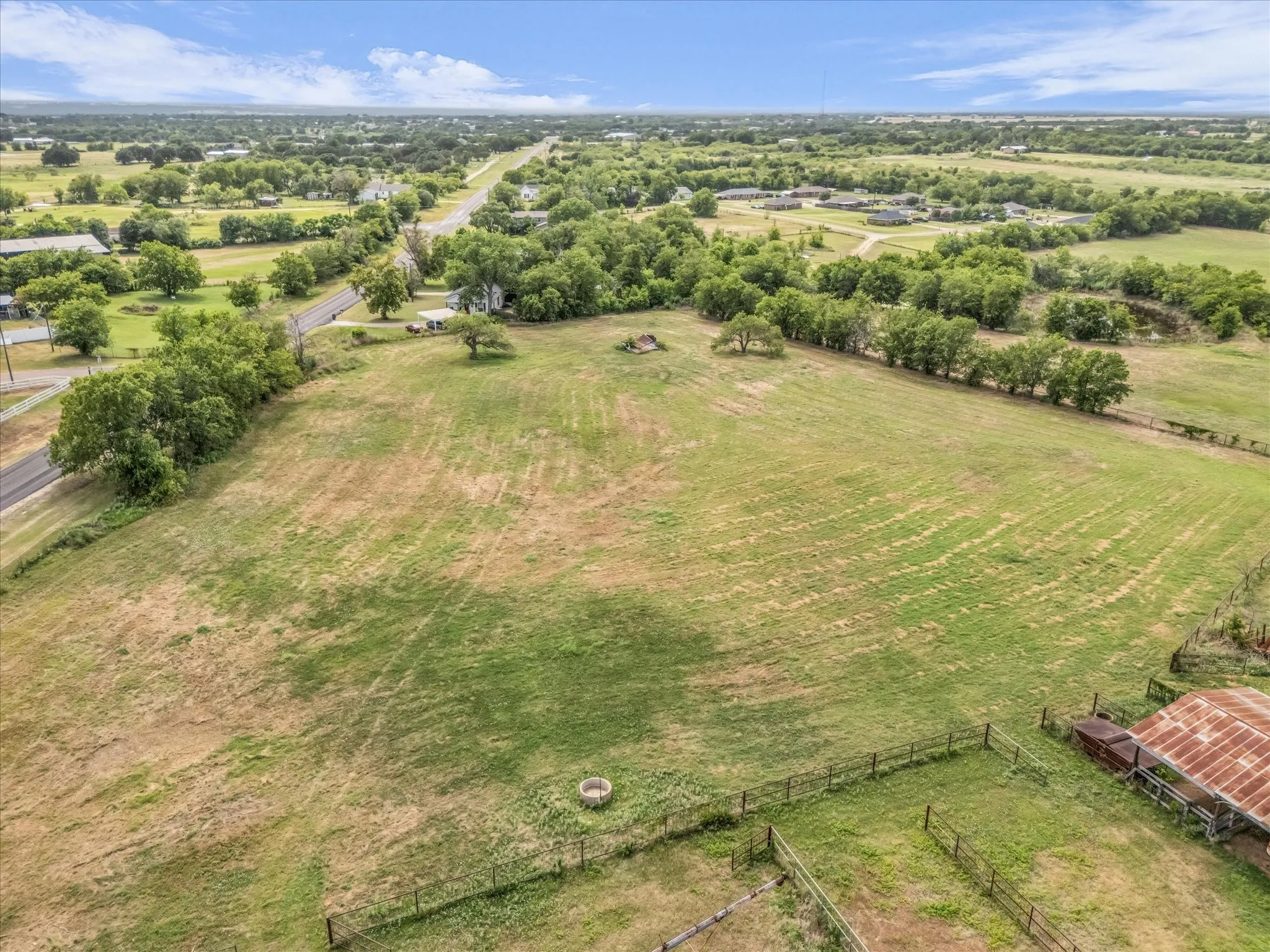 Aerial view of sparsely populated area featuring a tree filled landscape
