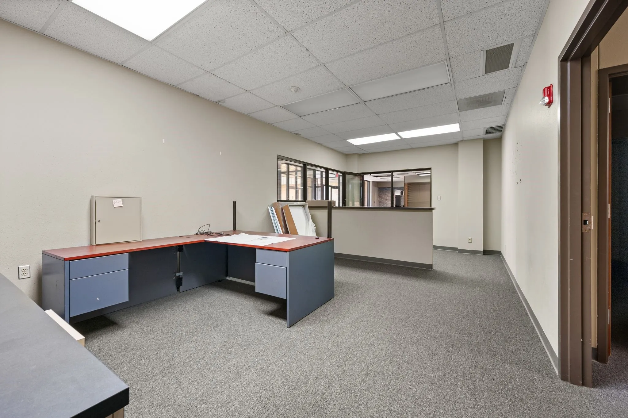 Unfurnished office featuring a paneled ceiling and carpet flooring