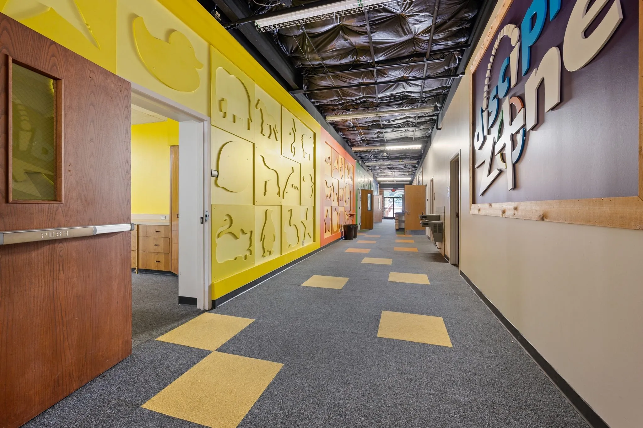 Hall with dark colored carpet and baseboards