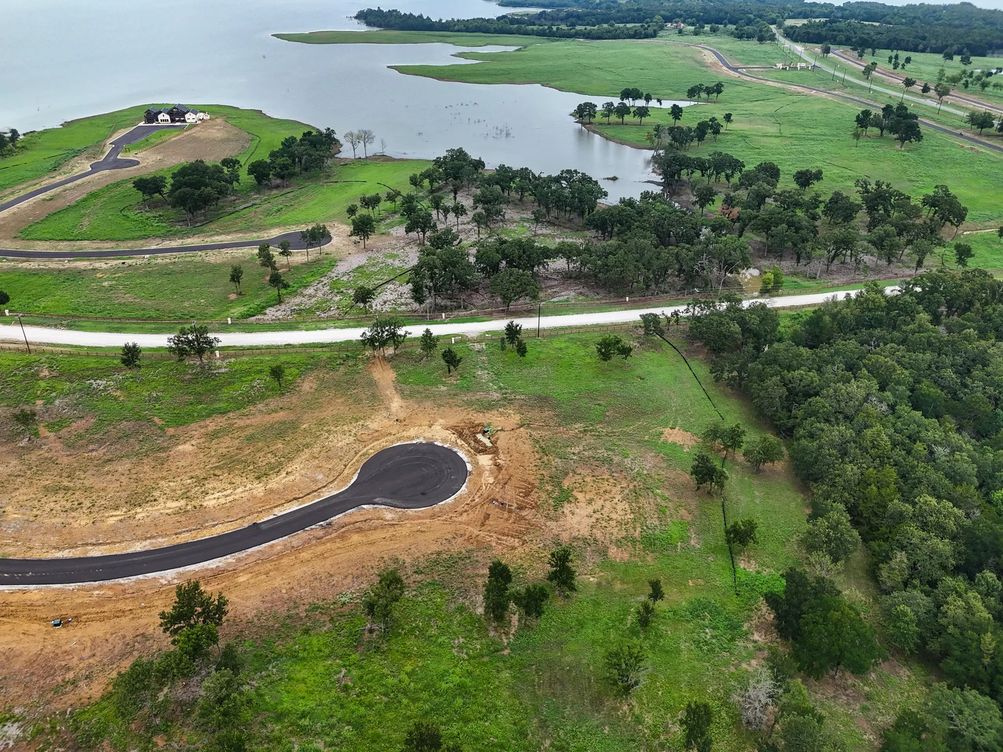 Aerial view of property and surrounding area with a nearby body of water