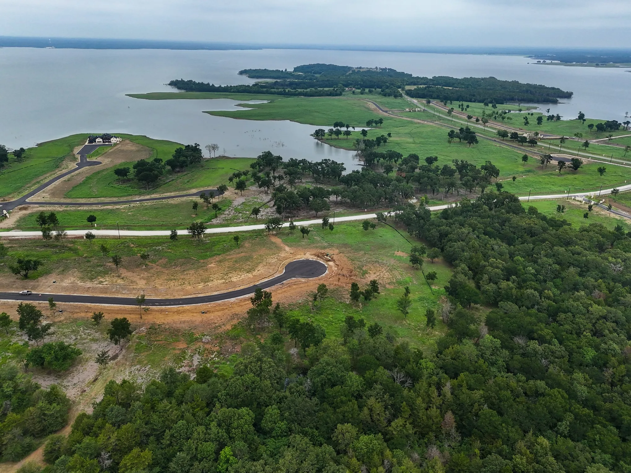 Aerial overview of property's location with a nearby body of water