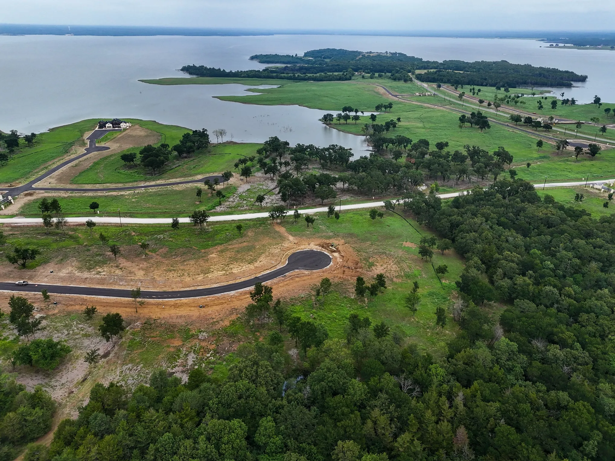 Aerial overview of property's location with a nearby body of water