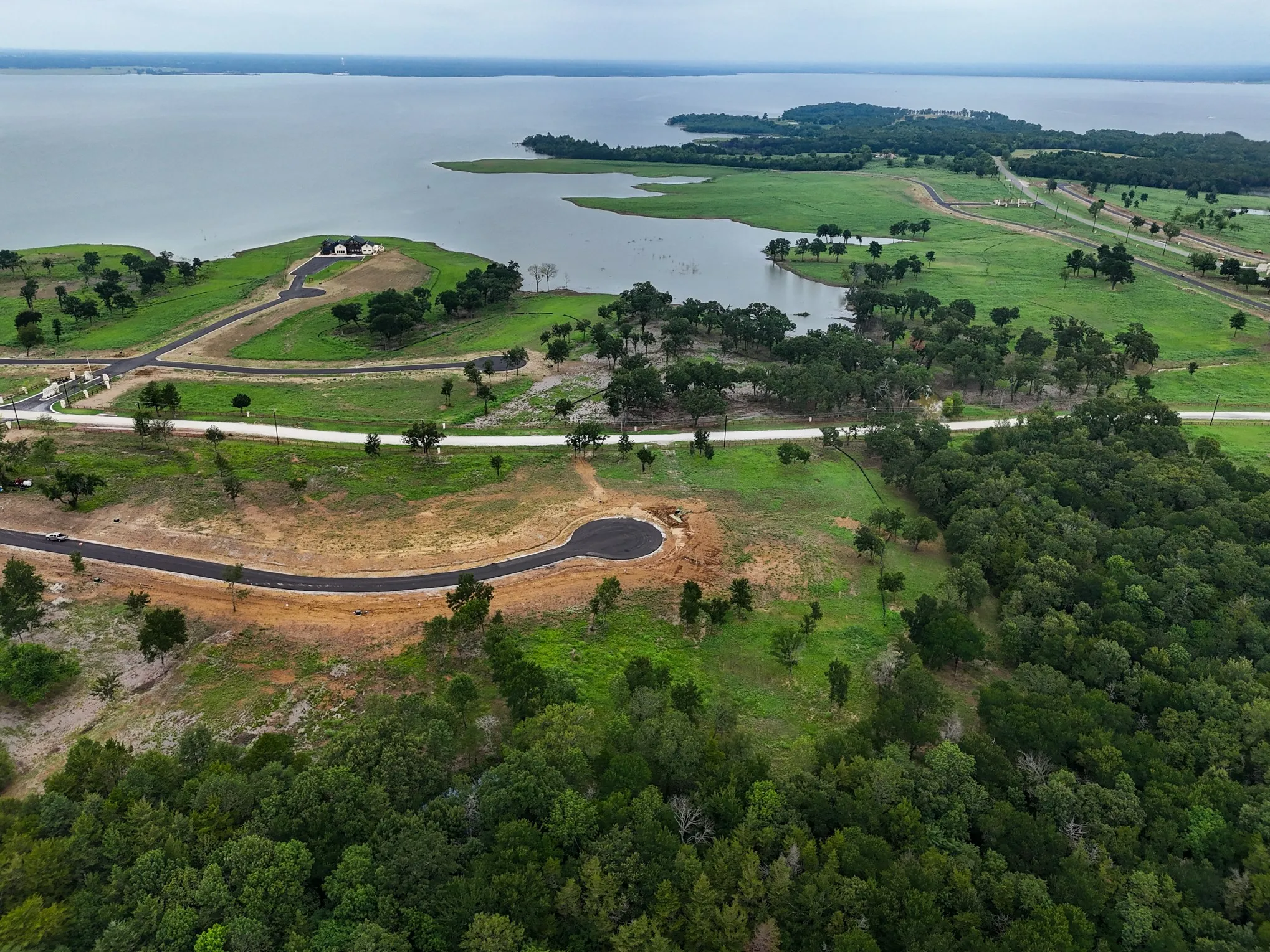 Aerial view of property and surrounding area featuring a large body of water