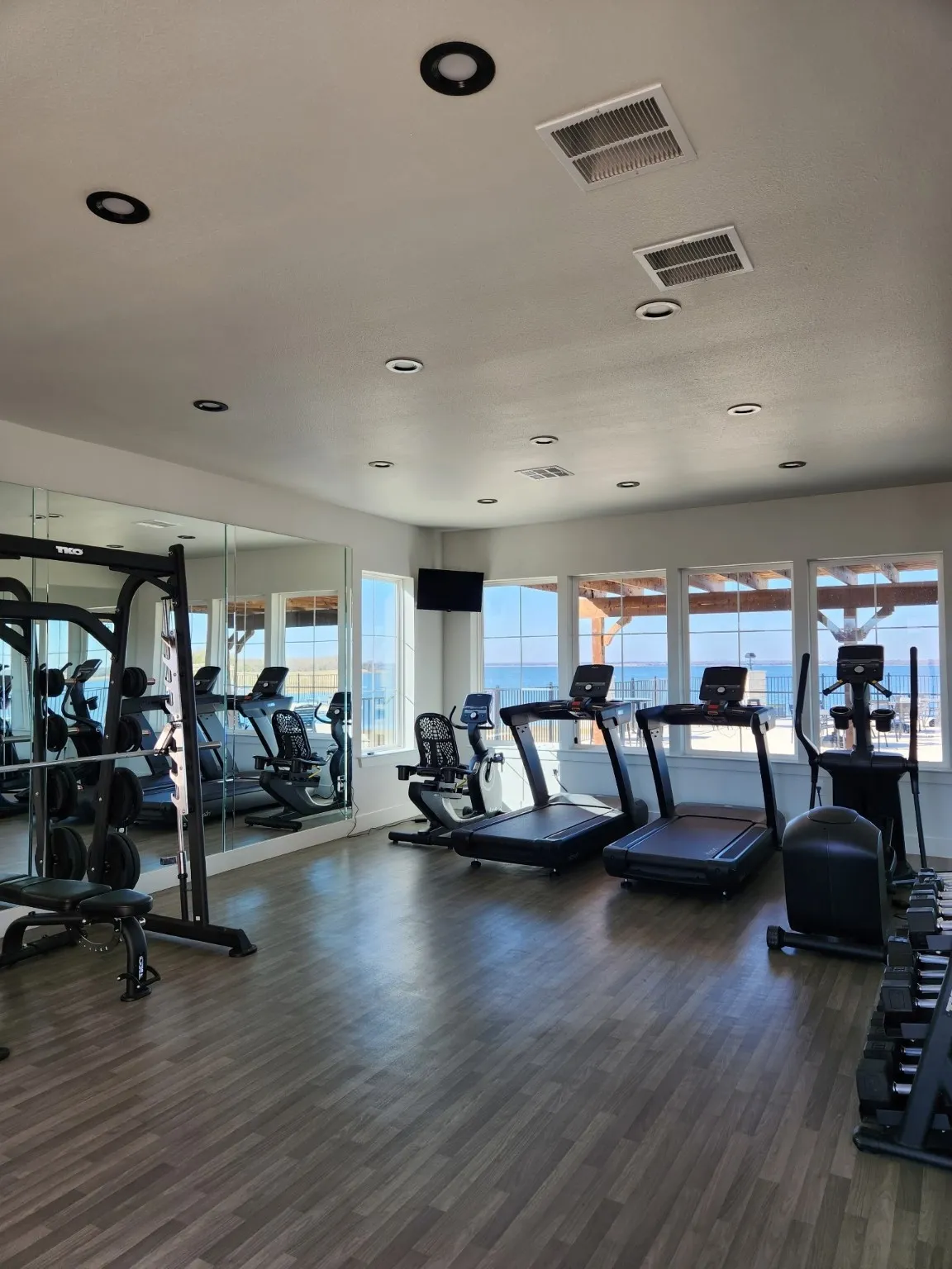 Workout area featuring dark wood-type flooring and recessed lighting