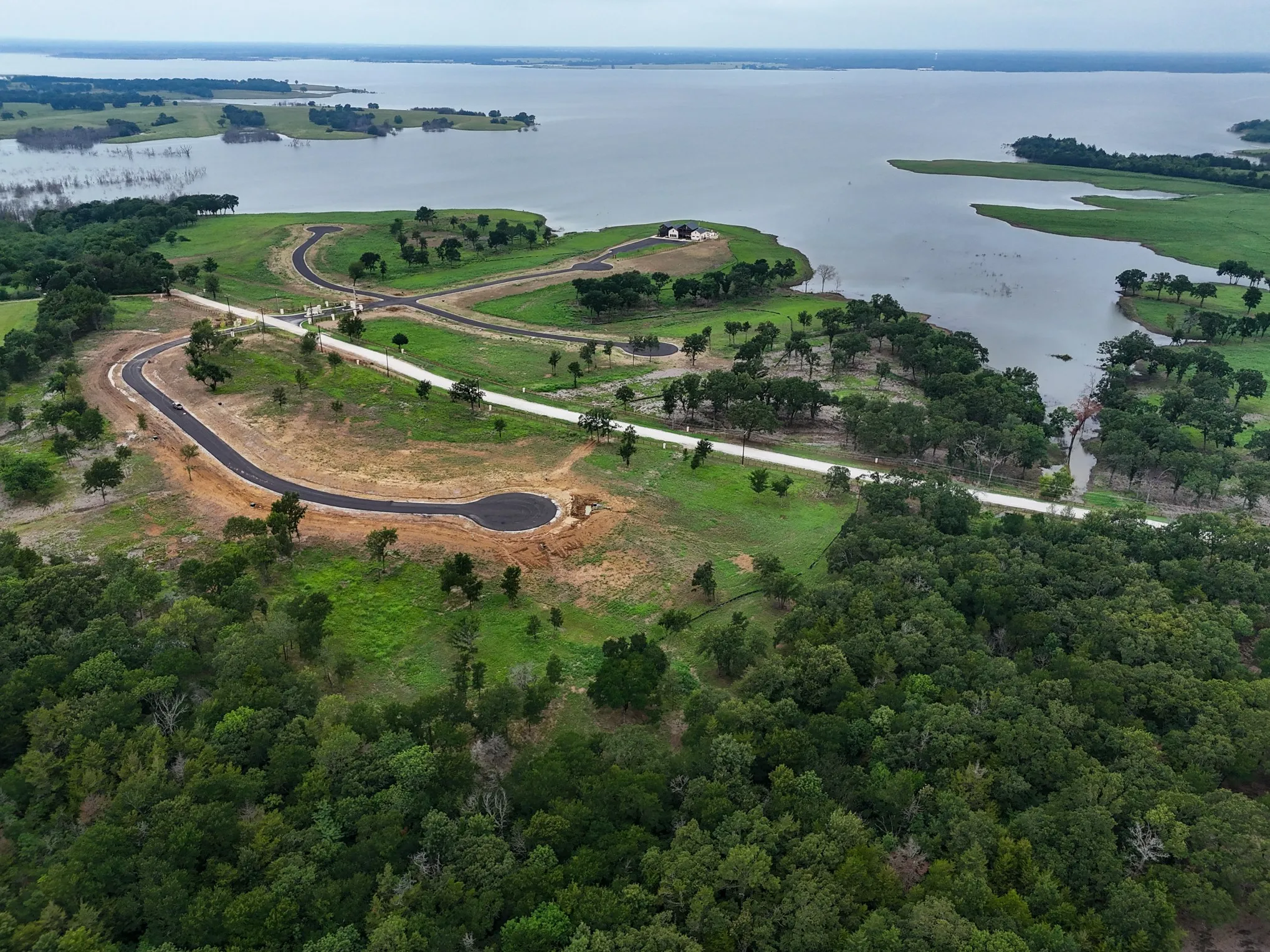 Aerial overview of property's location with a large body of water