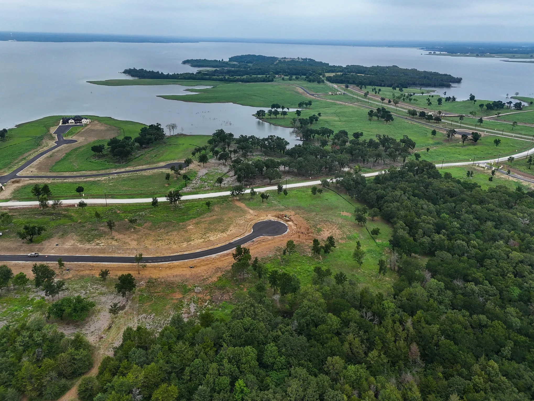 Aerial view of property's location featuring a large body of water