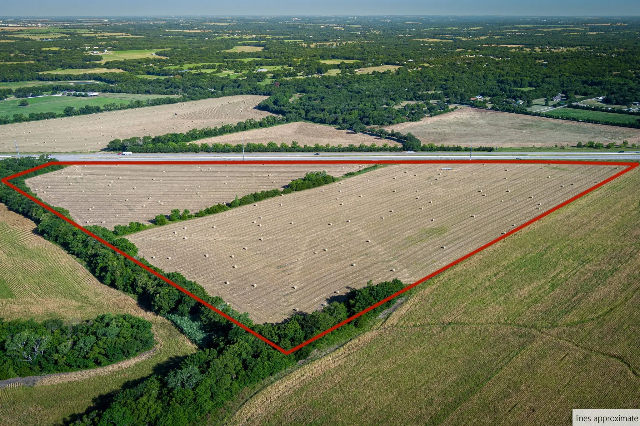 Aerial view of sparsely populated area with property parcel outlined