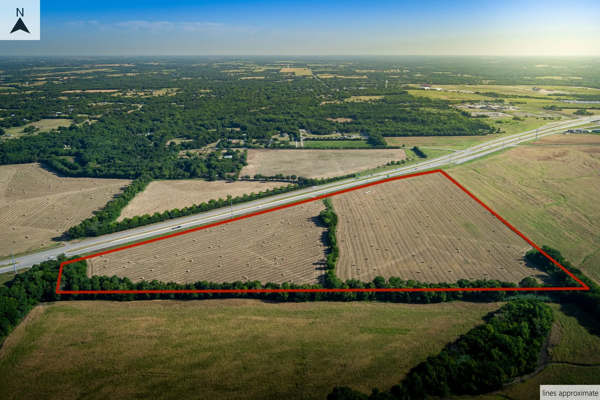 Overview of rural landscape featuring property boundaries highlighted and large plots for crops