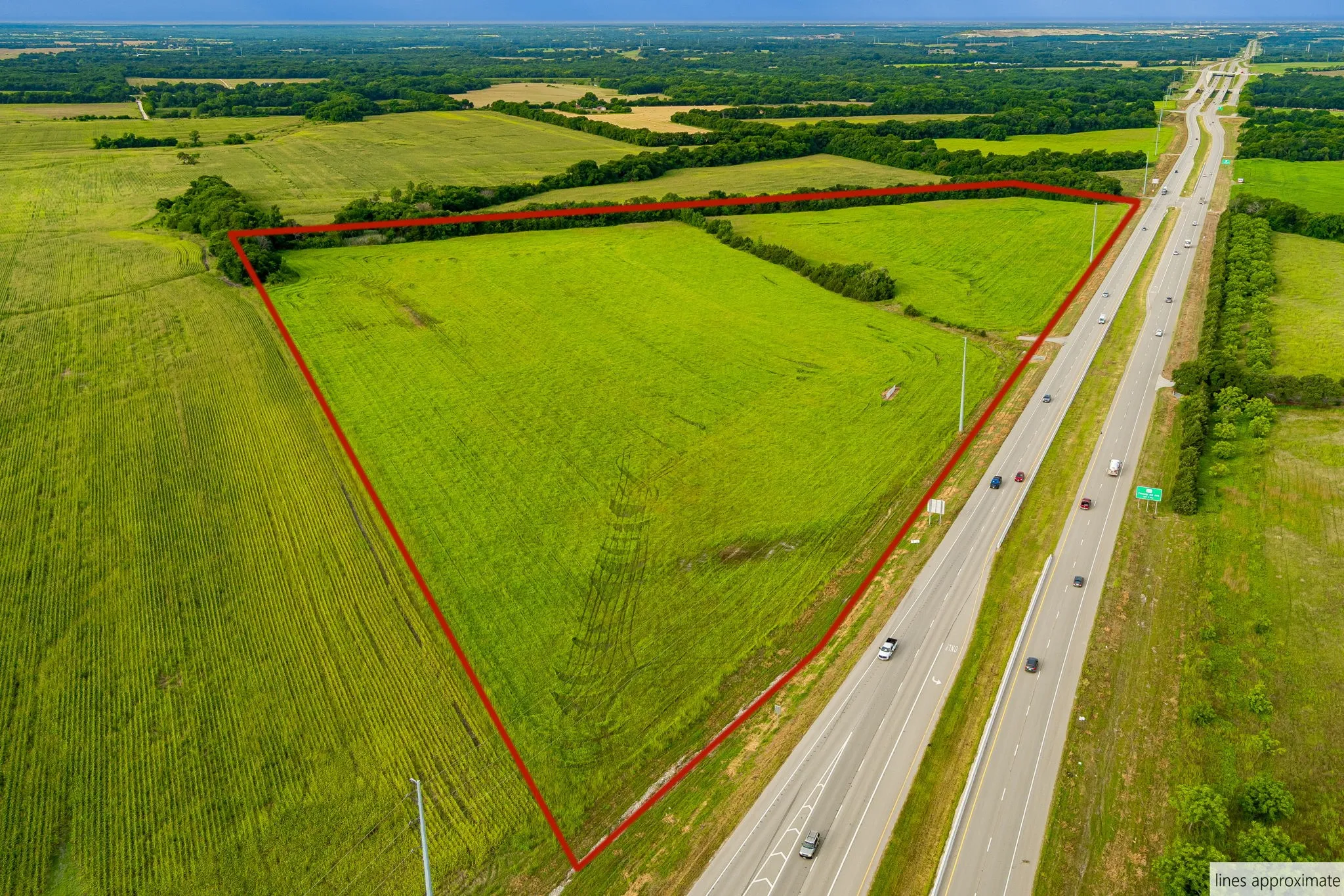 Aerial view of sparsely populated area with property boundaries highlighted and rows of crops