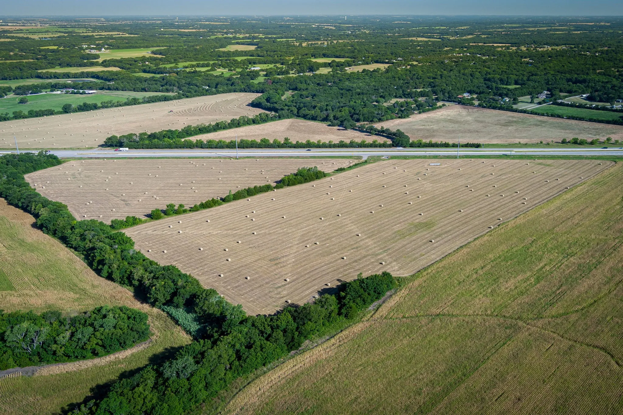 Aerial view of property's location featuring rural landscape and extensive farmland