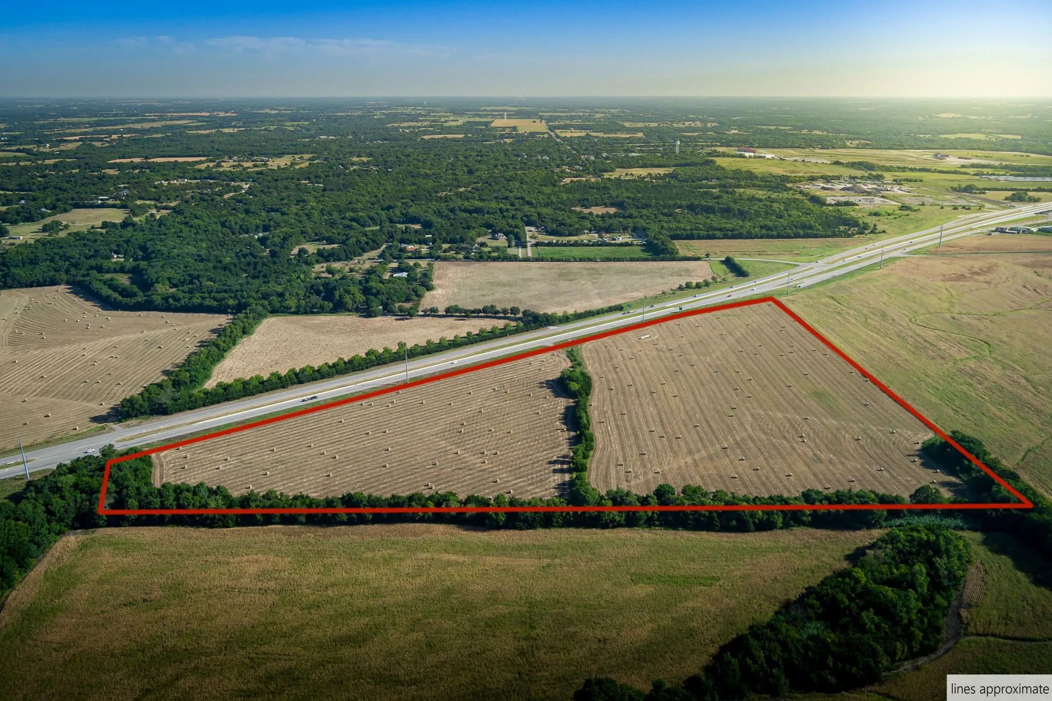 Aerial view of sparsely populated area featuring property parcel outlined and abundant farmland