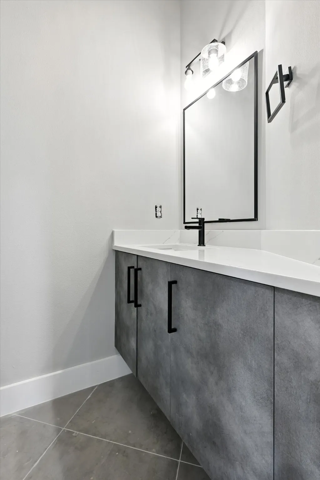 Bathroom with vanity and concrete floors