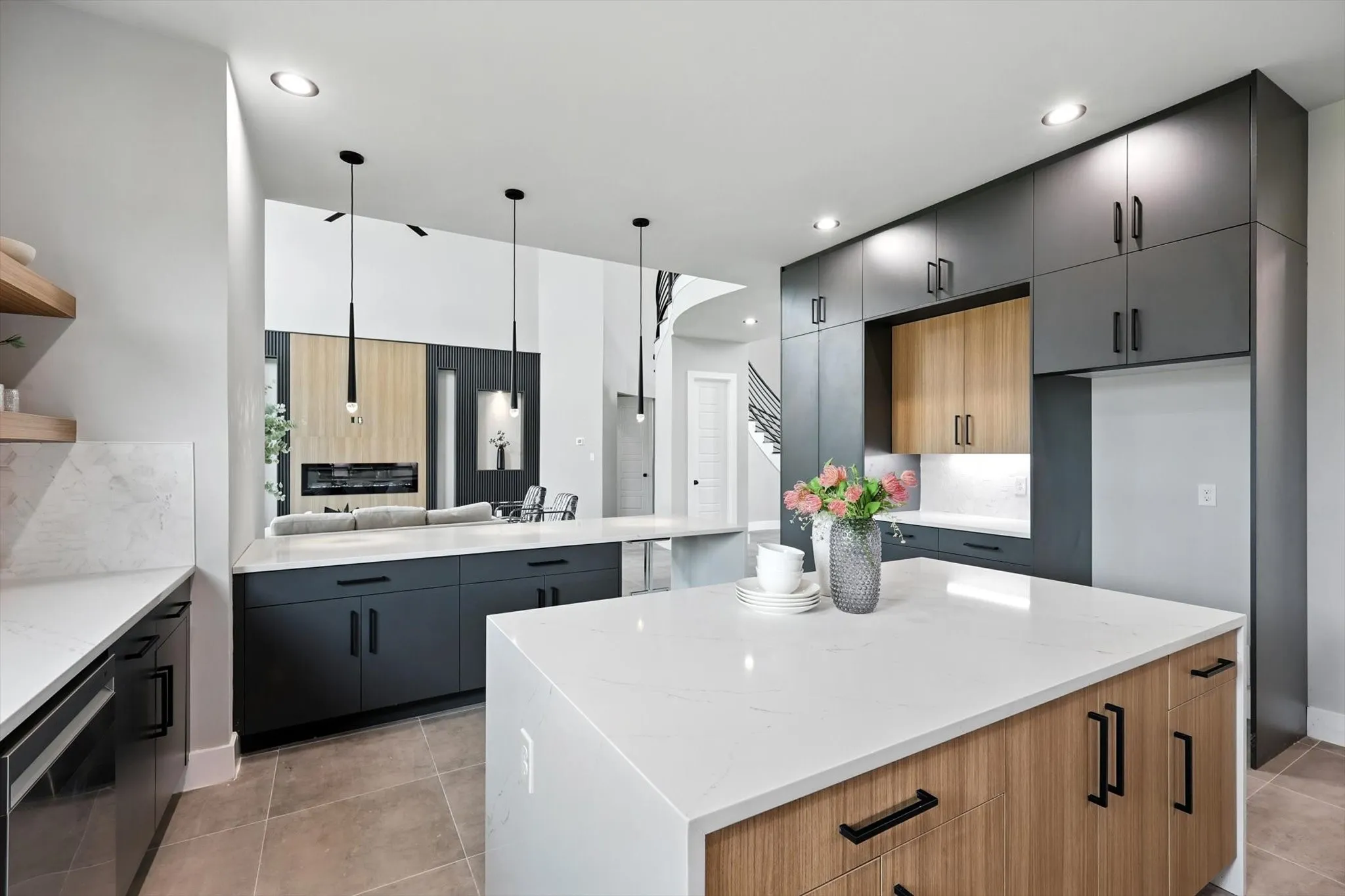 Kitchen with light tile patterned floors, stainless steel dishwasher, light stone countertops, a kitchen island, and recessed lighting