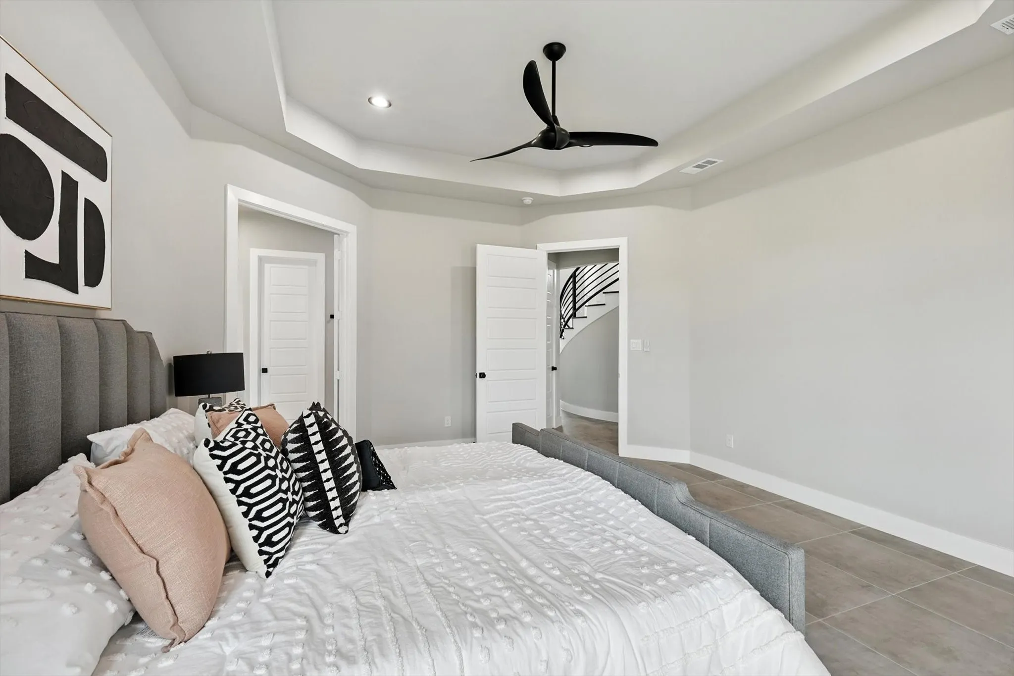 Bedroom with a raised ceiling, tile patterned floors, a ceiling fan, and recessed lighting