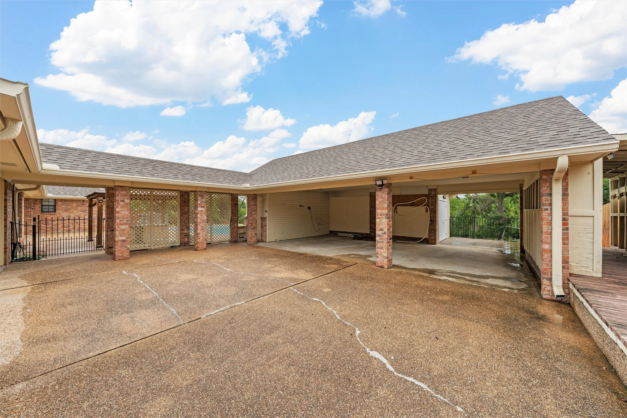 View of parking with asphalt driveway and a 3 car carport