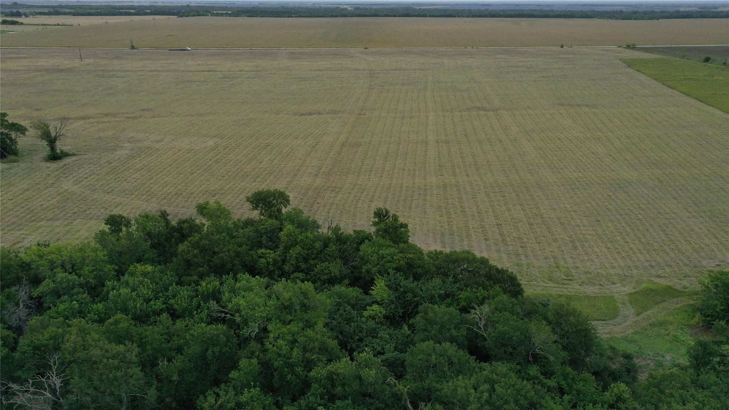 Aerial overview of property's location featuring rural landscape and extensive farmland
