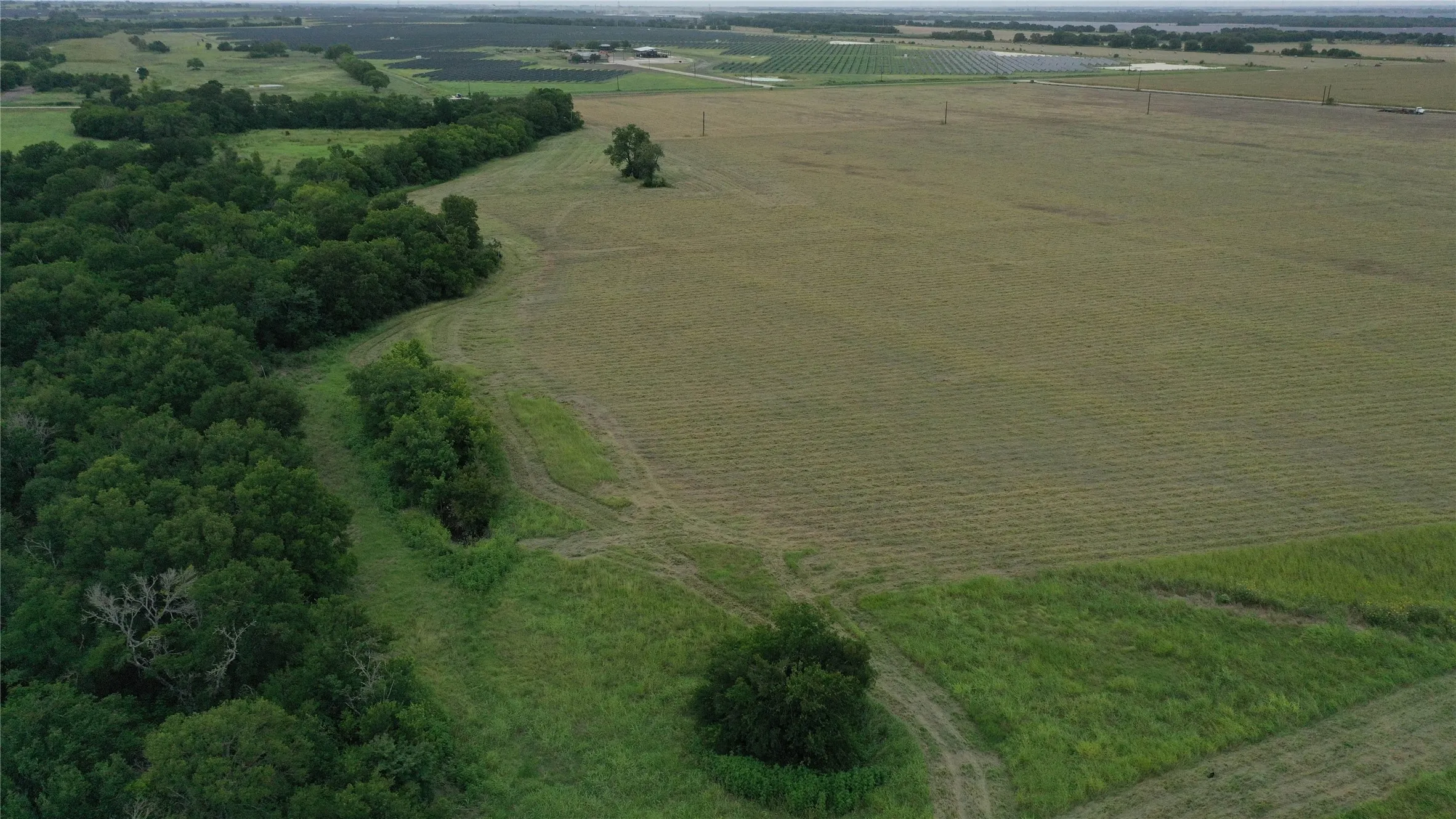 Aerial view of property's location featuring rural landscape and farmland