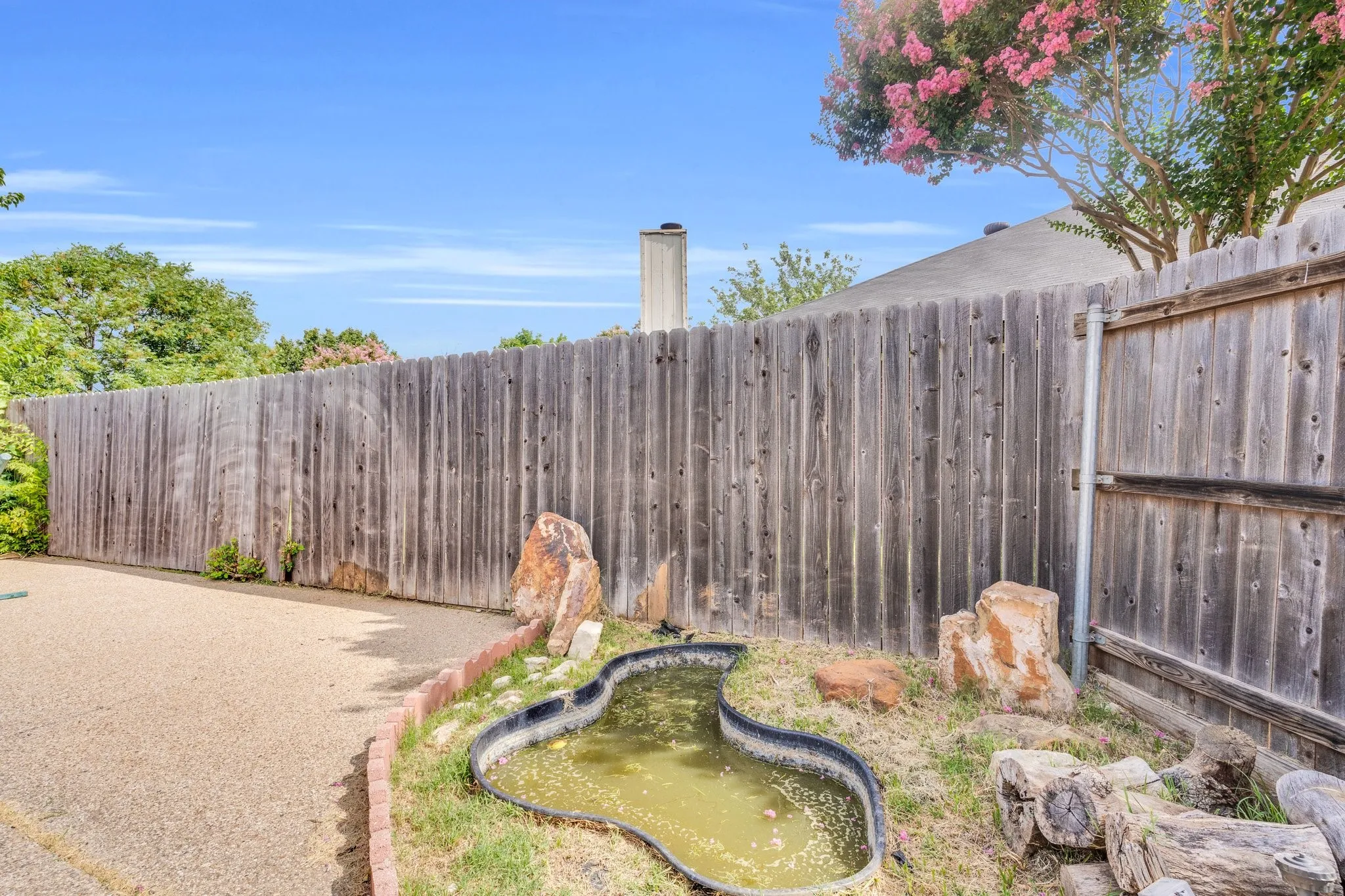 View of yard featuring a small pond