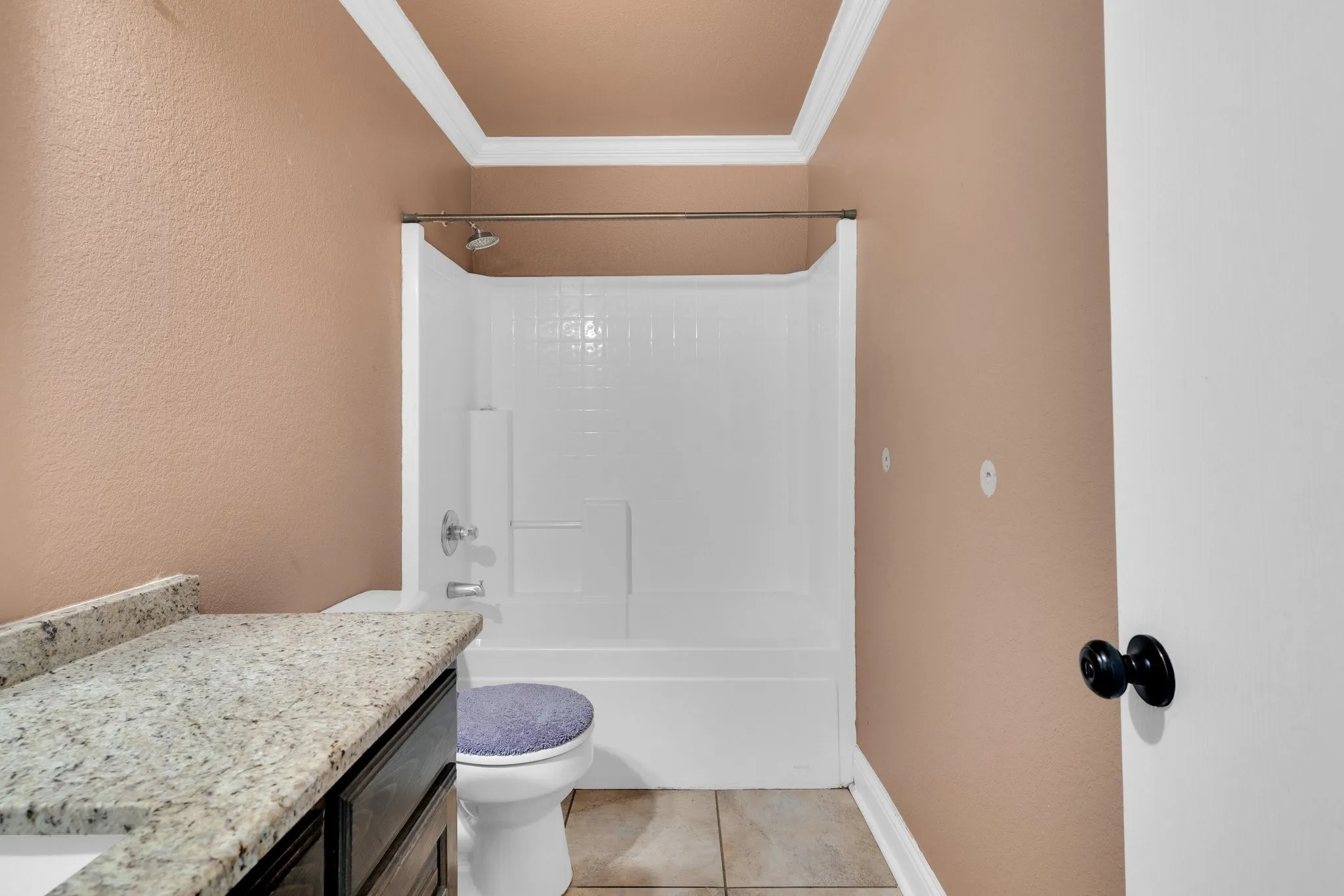 Full bathroom featuring ornamental molding, vanity, shower / bathtub combination, and tile patterned floors