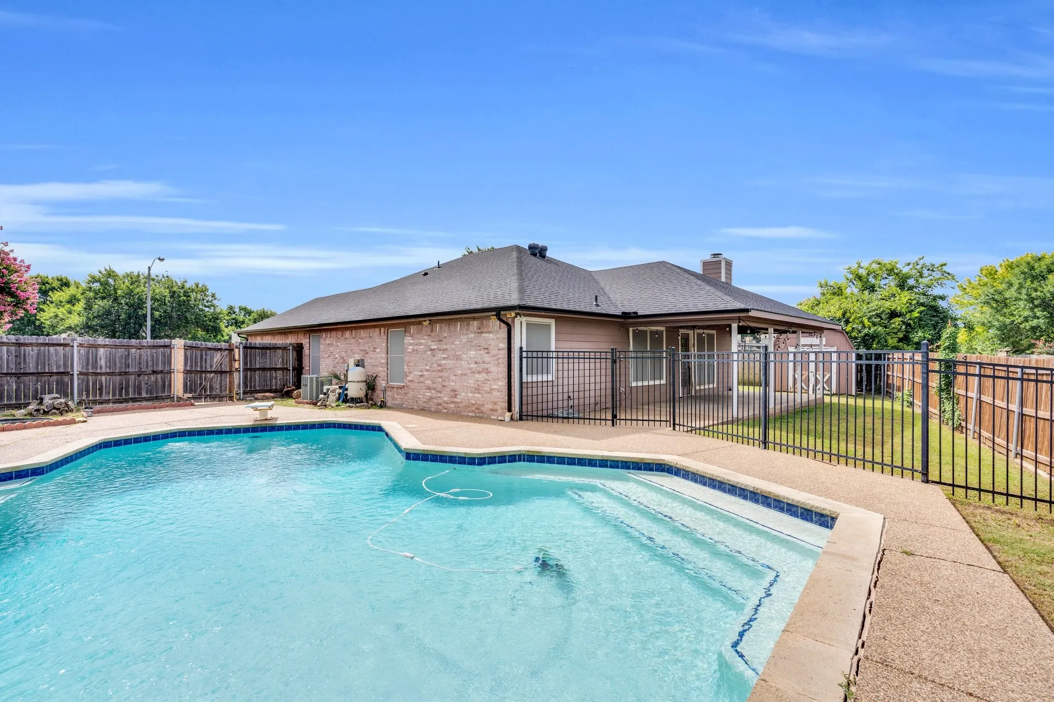 View of pool featuring a fenced backyard and a patio area