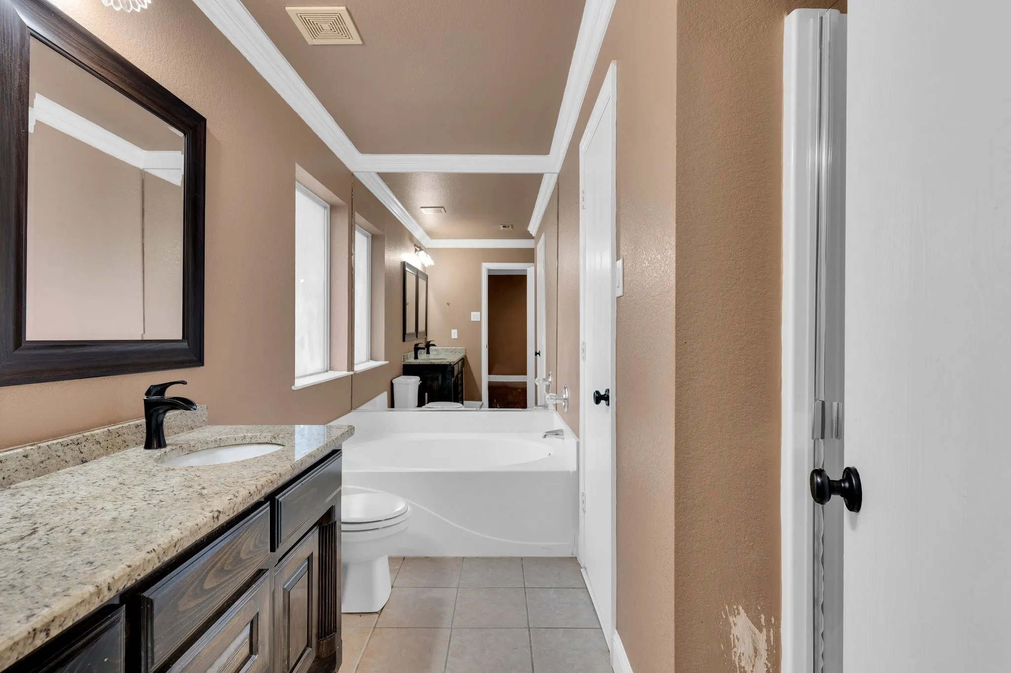 Full bathroom with ornamental molding, vanity, tile patterned flooring, and a bath