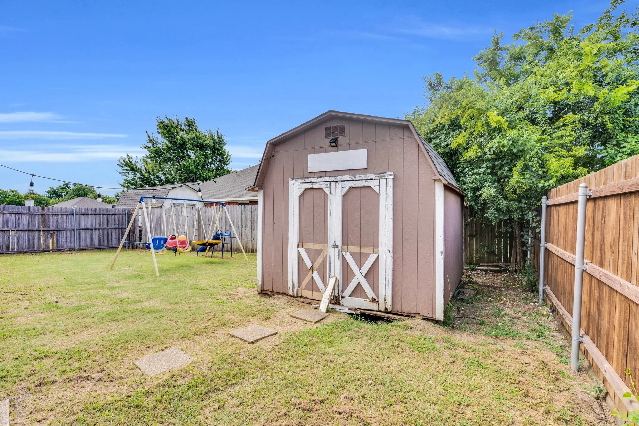 View of shed with a fenced backyard