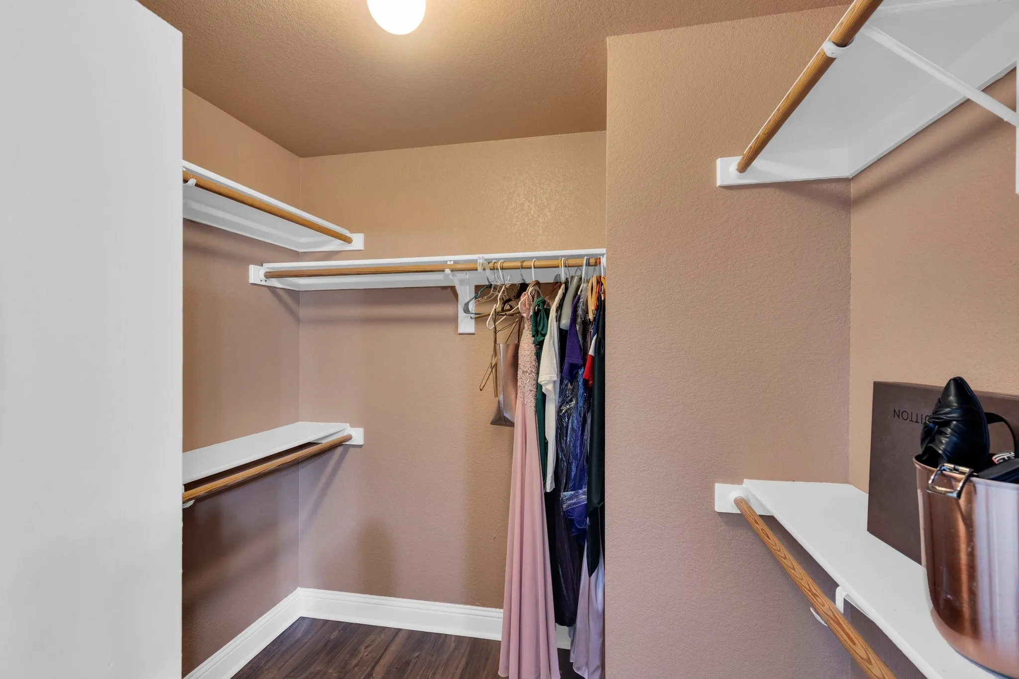 Walk in closet featuring dark wood finished floors