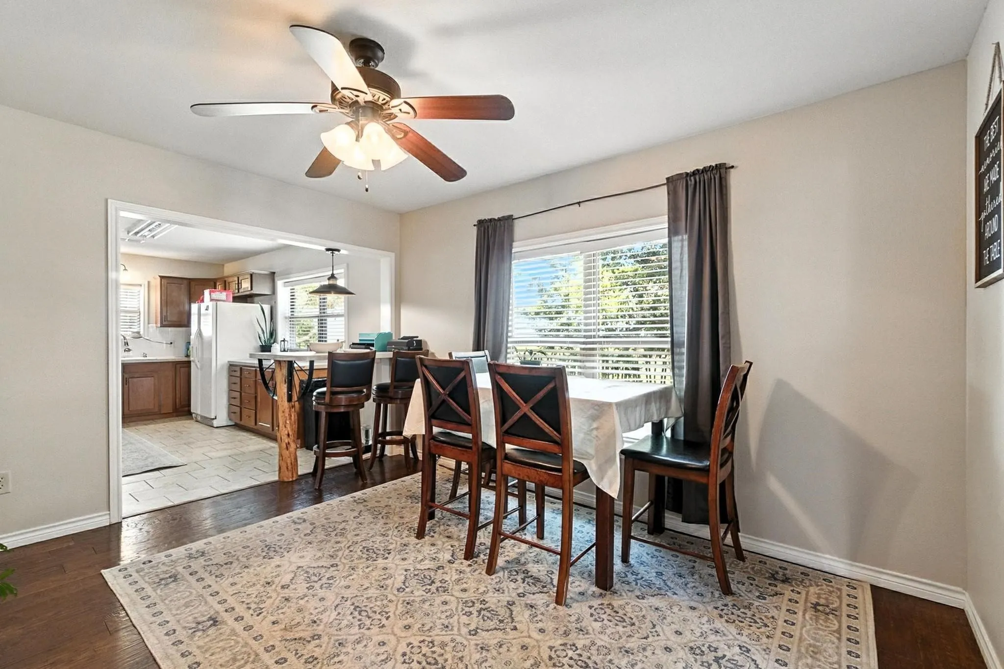 Dining space featuring healthy amount of natural light, ceiling fan, and light wood-type flooring