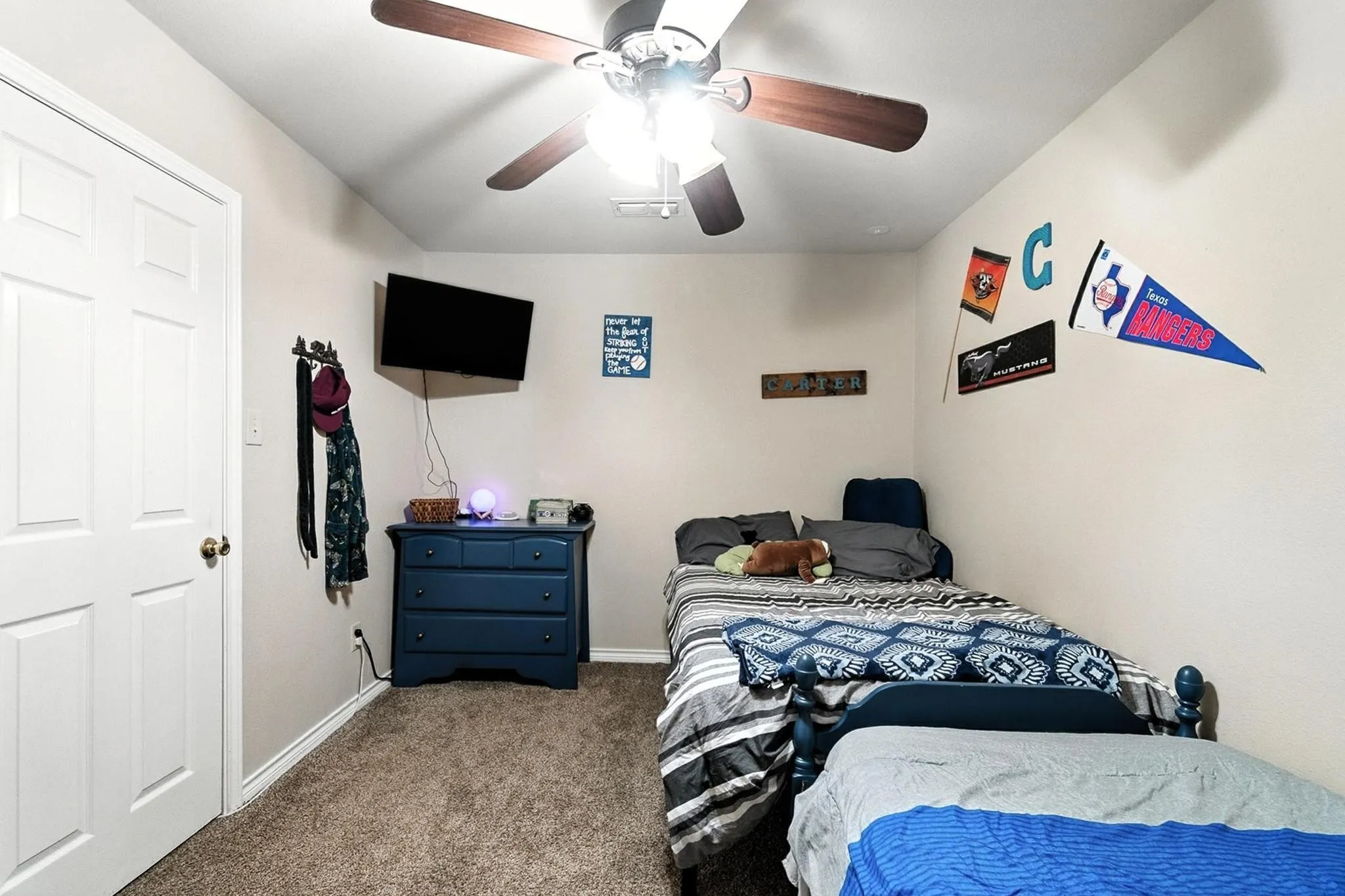 Carpeted bedroom featuring baseboards and ceiling fan