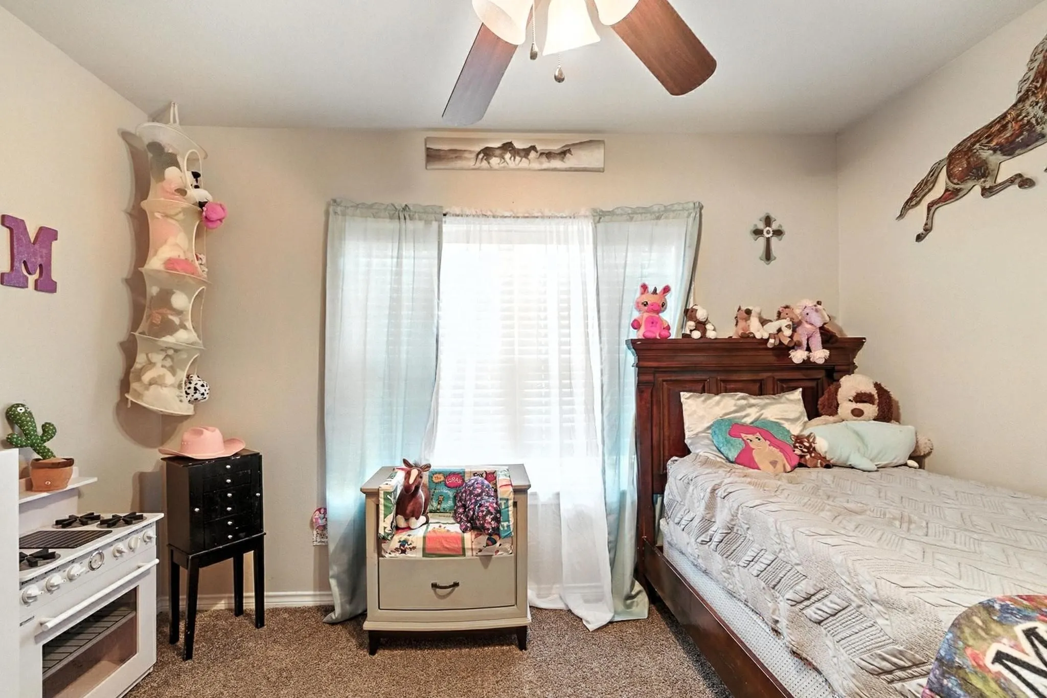 Carpeted bedroom with ceiling fan