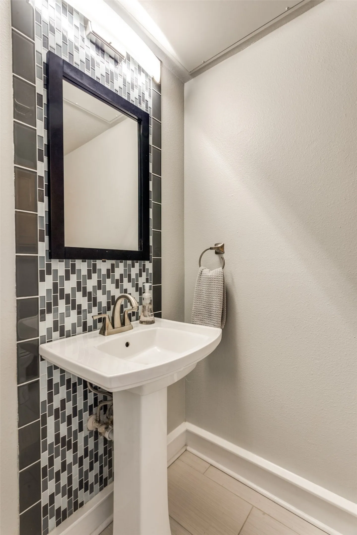 The half bath is located near the front door.